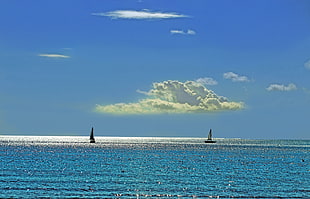 two sailing boat in body of water during day time