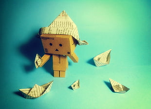 Danbo in paper hat holding a paper boat