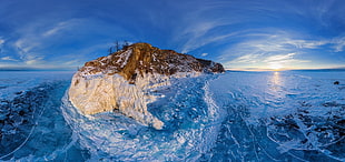 beige and brown mountain surrounded by water under blue sky, Lake Baikal, winter, ice, frost