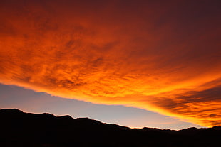 orange cloud and brown mountain