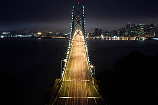 time lapse photography of cars on bridge during nighttime