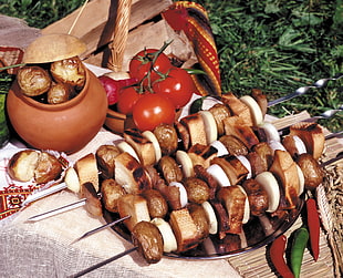 barbecue and tomatoes on beige mat