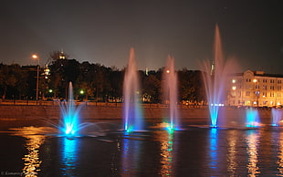 lighted water dancing fountains during night time HD wallpaper
