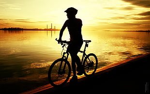 silhouette of man riding bike, sunlight, sport , bicycle