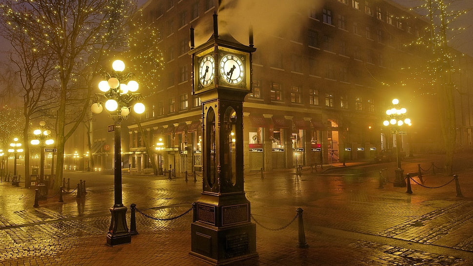 brown clock near road and lampposts HD wallpaper