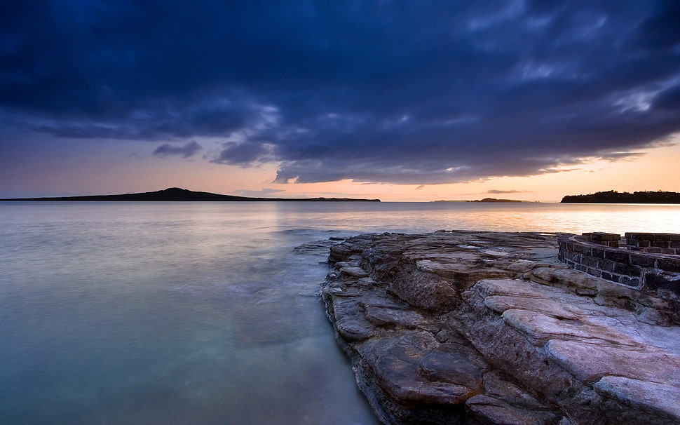 white and beige stone with body of water long exposure photography HD wallpaper