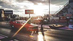 red Ford Mustang on drag race during daytime HD wallpaper