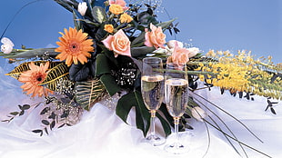 photography of clear wine glass near assorted flowers