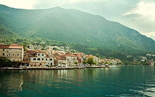 houses near body of water, town, mountains, water