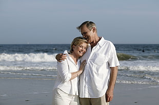 man and woman hugging and smiling near shore during daytime