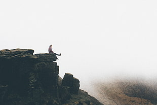 photo of man sitting on top of the mountain HD wallpaper