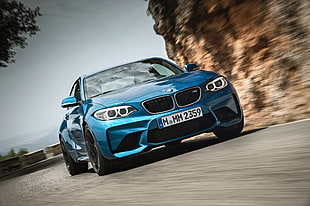teal BMW 1 series along highway during daytime HD wallpaper