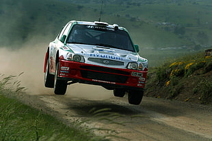 white and red Hyundai rally car on mid air during daytime
