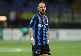 man wearing blue and black Nike striped soccer jersey
