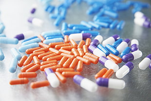 orange, blue, and white medication pills