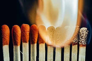 closeup photo of burning matchsticks