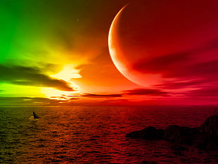 silhouette of seashore under red and green sky with the moon shining