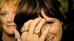 selective focus photography of woman wearing three gold-colored rings