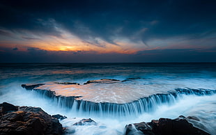 waterfalls and gray clouds, nature, sea, waves, sunset