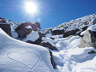 heart draw on snow filled mountain photo during daytime