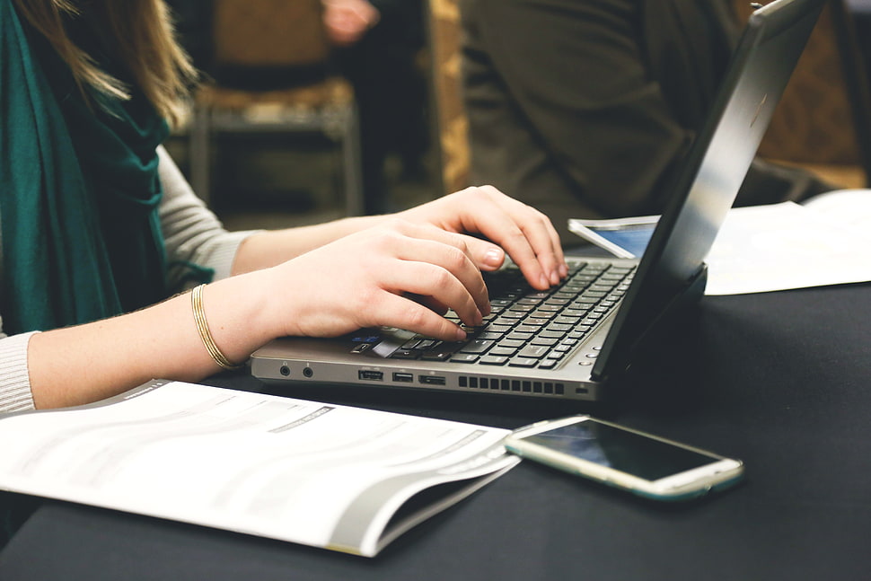person working on her laptop HD wallpaper