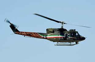green helicopter flying on air