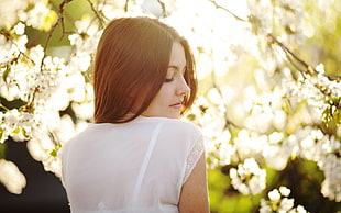 tilt lens photography of brown haired woman with white blouse