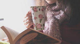 white and pink floral ceramic mug, tea, books, scarf, floral
