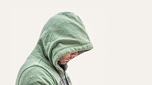 person wearing a green hoodie jacket