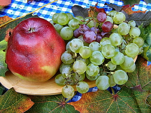 served bunch of grapes and red fruit on tray