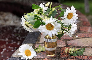 white petal flower in brown wooden barrel themed vase