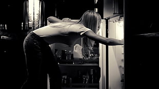woman opens the door of the refrigerator