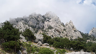 rock mountain under cloudy sky at daytime
