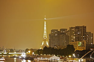 Eiffel tower with lights and high rise buildings, paris