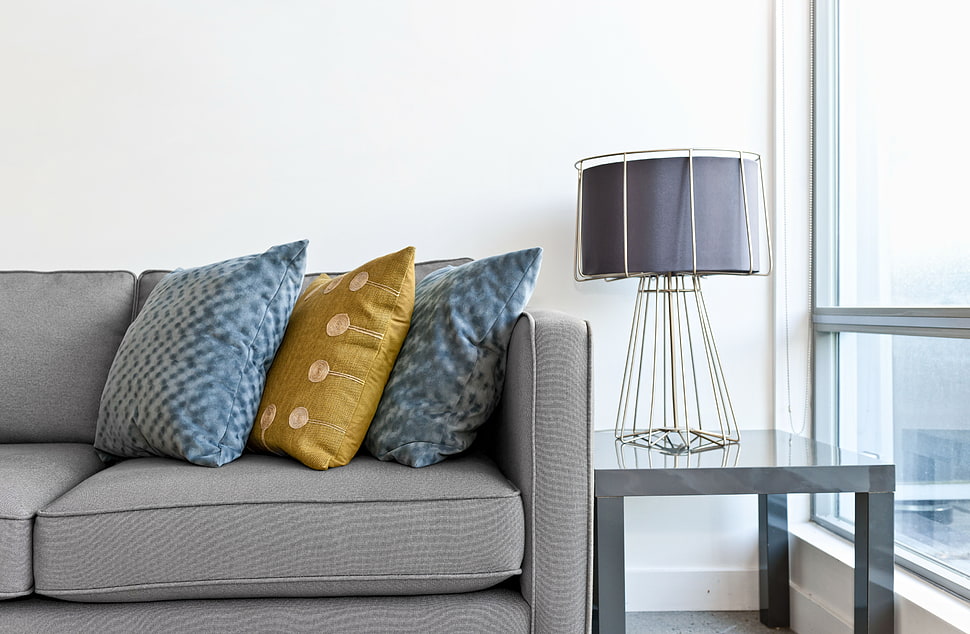 white table lamp base with black lamp shade besides gray leather sofa HD wallpaper