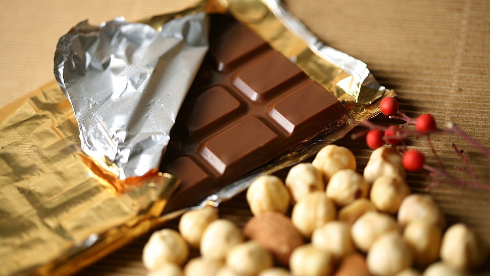opened chocolate bar beside nuts HD wallpaper