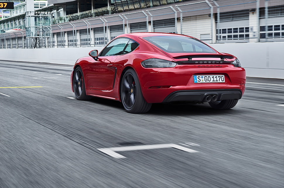 red coupe on gray concrete road during daytime HD wallpaper