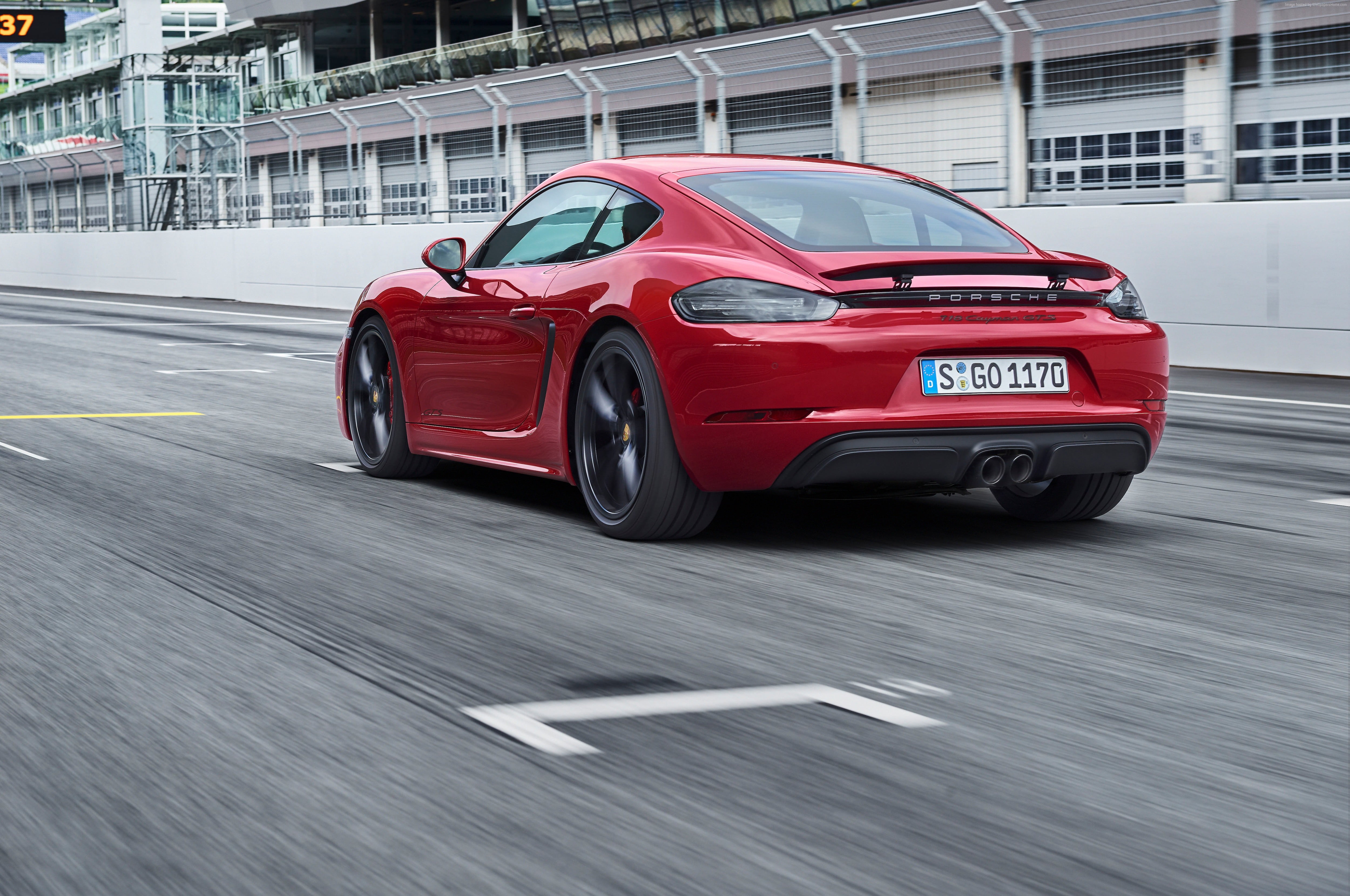 red coupe on gray concrete road during daytime