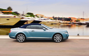 photo of blue convertible on gray road HD wallpaper