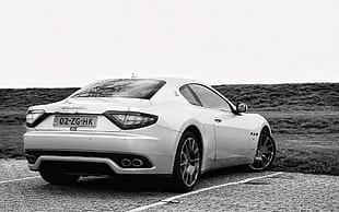 grey scale photo of white coupe