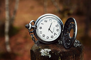round silver-colored pocket watch