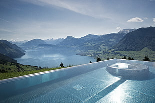 calm body of water, swimming pool, mountains