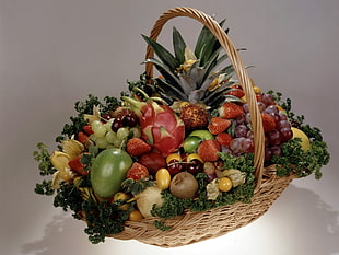 still life photography of plenty of fruits on wicker basket