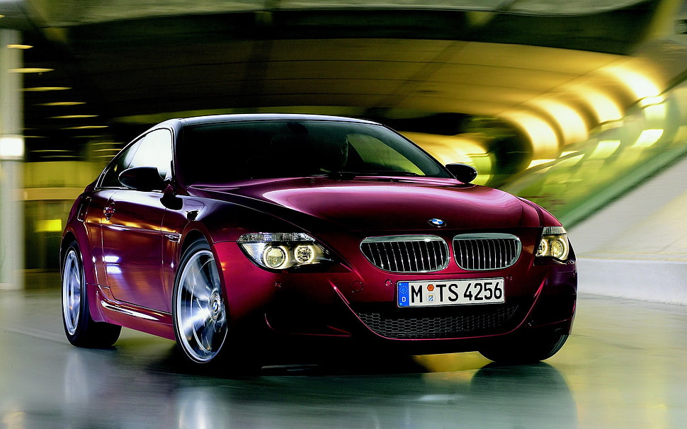 selective blur maroon BMW coupe parked on concrete ground HD wallpaper