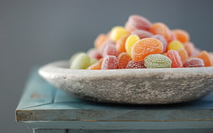 assorted color candies on round white bowl HD wallpaper