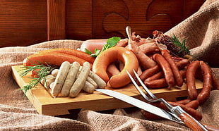 assorted sausages on chopping board