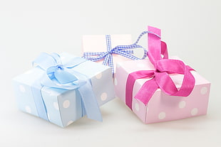 close up photo of two pink and one blue polka-dot girt boxes