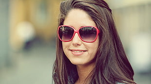 woman wearing red frame over size sunglasses