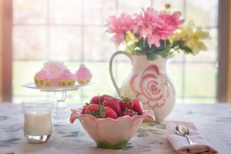 flower on vase, milk on cup, strawberries on bowl and cupcake on stand on top of table HD wallpaper