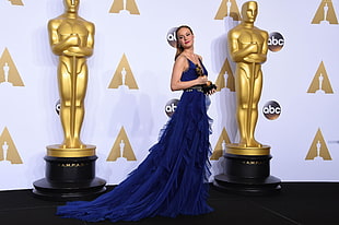 woman wearing blue sleeveless gown